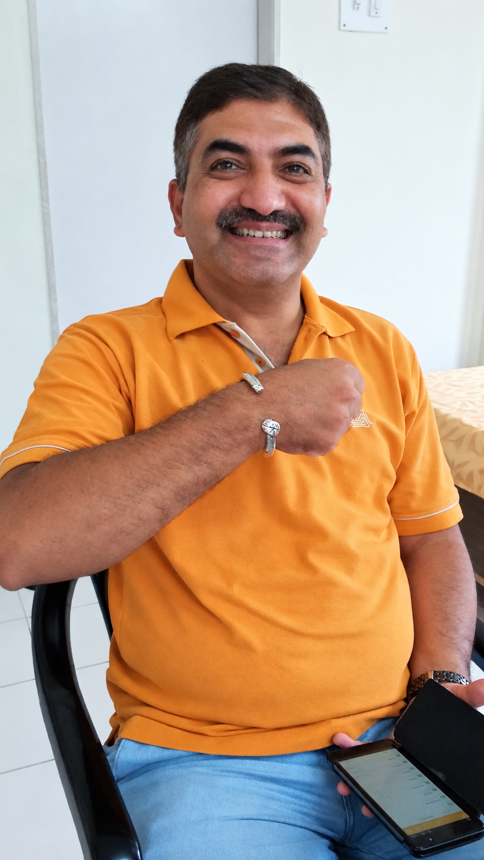 Jeetesh showing his silver bracelet